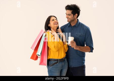 A YOUNG MAN HAPPILY LOOKS AT WIFE WHILE SHE LAUGHS Stock Photo