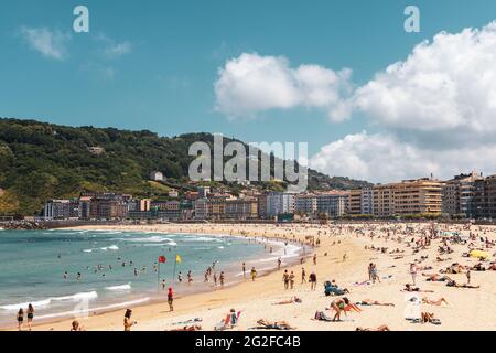 Crowded Zurriola Beach Donostia San Sebastian, Basque Country, Spain - Panorama Stock Photo