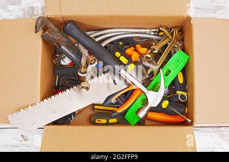 top view of various handyman tools in cardboard box Stock Photo