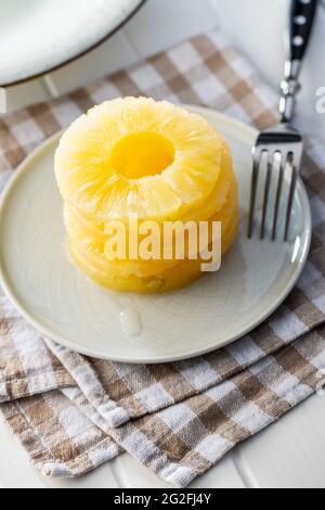 Canned sliced pineapple fruit on plate. Stock Photo