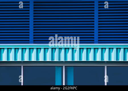 Close up of a blue bulding exterior with windows and blinds Stock Photo