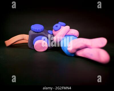 clay cartoon sleeping with camera kept like pillow on black background, Photographer concept Stock Photo