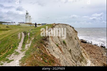 Walker approaching St Catherine's Lighthouse at St Catherine's Point on the southernmost point of the Isle of Wight in Hampshire UK Stock Photo