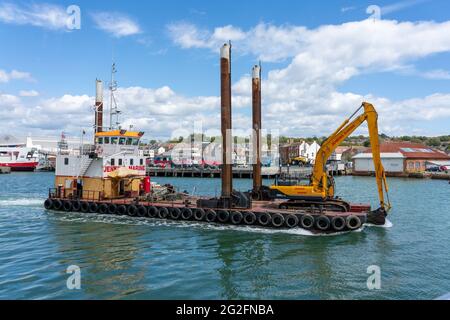 Dredger sailing up the Cowes River on the Isle of Wght in Hampshire UK Stock Photo