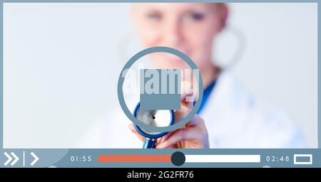 Composition of female doctor holding stethoscope on video playback interface screen Stock Photo