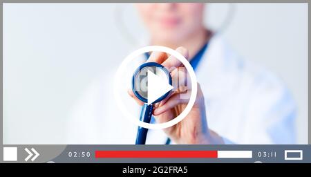 Composition of female doctor holding stethoscope on video playback interface screen Stock Photo