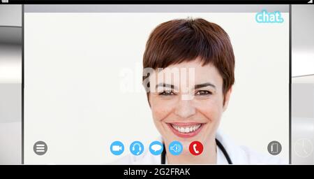 Composition of female doctor smiling on video call interface screen Stock Photo