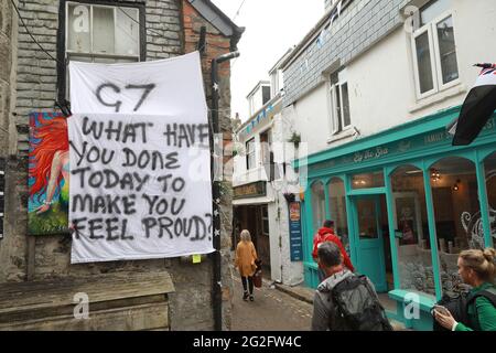 St Ives, Cornwall, UK. 11th June, 2021. Day one of three days of protest by a cariety of protest groups, saw Extinction Rebellion march through the seaside town of St Ives near to Carbis Bay to draw attention to the climate crisis and more. Credit: Natasha Quarmby/Alamy Live News Stock Photo