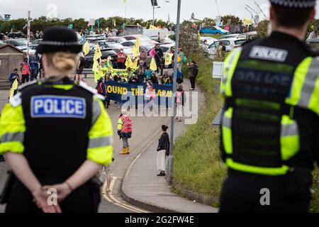 St Ives, UK. 11th June, 2021. Hundreds of protesters march through St Ives village near where delegates are meeting for the 47th G7. Extinction Rebellion organised the demonstration to coincide with the G7-Summit. The event sees world leaders come together to discuss matters around climate change. Credit: Andy Barton/Alamy Live News Stock Photo