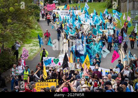 St Ives, UK. 11th June, 2021. Hundreds of protesters march through St Ives village near where delegates are meeting for the 47th G7. Extinction Rebellion organised the demonstration to coincide with the G7-Summit. The event sees world leaders come together to discuss matters around climate change. Credit: Andy Barton/Alamy Live News Stock Photo