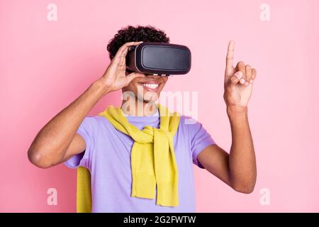 Photo of young african guy happy positive smile wear virtual reality glasses look finger isolated over pastel color background Stock Photo