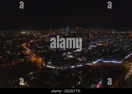 Aerial night view of Dubai Skyline under dark Sky, Dubai Downtown Residential and Business Skyscrapers, a view from Dubai Water Canal Stock Photo