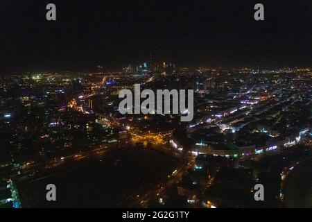 Aerial night view of Dubai Skyline under dark Sky, Dubai Downtown Residential and Business Skyscrapers, a view from Dubai Water Canal Stock Photo