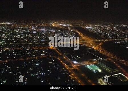 Aerial night view of Dubai Skyline under dark Sky, Dubai Downtown Residential and Business Skyscrapers, a view from Dubai Water Canal Stock Photo