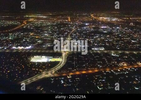 Aerial night view of Dubai Skyline under dark Sky, Dubai Downtown Residential and Business Skyscrapers, a view from Dubai Water Canal Stock Photo