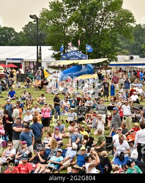 Thousands of aviation enthusiasts and pilots gather adjacent to the runway for the air show at the EAA Fly-In (AirVenture), Oshkosh, Wisconsin, USA Stock Photo