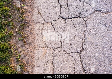 asphalt texture with cracks on rural road Stock Photo