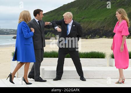 Newquay, UK. 11th June, 2021. French President Emmanuel Macron accompanied by his wife Brigitte Macron, bumps elbows with British Prime Minister Boris Johnson at the Carbis Bay Hotel on June 11, 2021, during the G7 summit in Cornwall, United Kingdom. Photo by David Fisher/G7 Cornwall 2021/UPI Credit: UPI/Alamy Live News Stock Photo