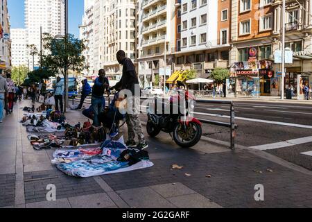 A street vendors, also named 'mantero', sells illegally merchandise on the Gran Vía Avenue. Madrid, Comunidad de Madrid, Spain, Europe Stock Photo