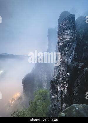 Nocturnal view from the Bastei bridge in the misty Elbe Sandstone Mountains. Stock Photo