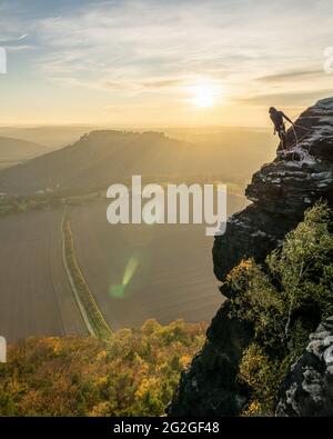 Sport climbers on the wall of the Lilienstein opposite the Königstein Fortress in the Elbe Sandstone Mountains. Stock Photo