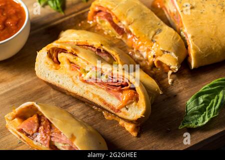 Homemade Italian Stromboli with Pepperoni Cheese and Peppers Stock Photo