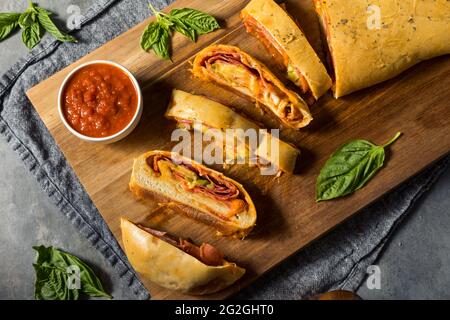Homemade Italian Stromboli with Pepperoni Cheese and Peppers Stock Photo