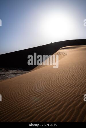 Two traveler climb one of the biggest dunes in the world in Sossusvlei National Park Stock Photo