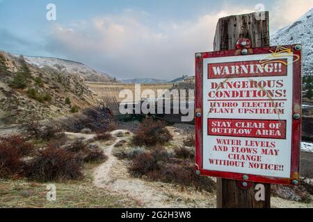 red sign warning of the dangers of swimming Stock Photo
