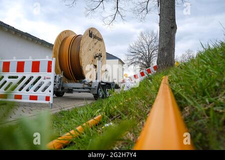 Rheinbach, North Rhine-Westphalia, Germany - Internet broadband expansion, construction site burial of fiber optic cable, cable drum with fiber optic cable, new construction of fiber optic routes on behalf of Telekom, fast Internet, DSL cable connection for households. Stock Photo