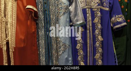 Moroccan dresses and fabrics in clothing store, fashion objects, Arabic Stock Photo