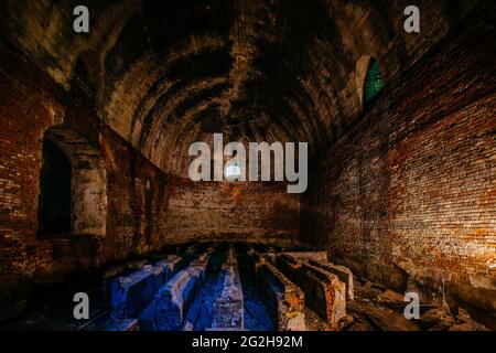 Large abandoned old underground red brick construction. Stock Photo
