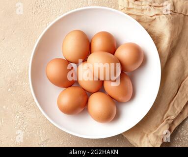 bowl of brown chicken eggs on kitchen table, top view Stock Photo