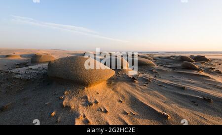 A strong wind off the Pacific Ocean has carved natural sculptures in the fine sand at South Beach on the Central Oregon Coast. Stock Photo