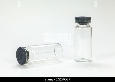 White background and several glass vaccine bottle with surgical needle Stock Photo