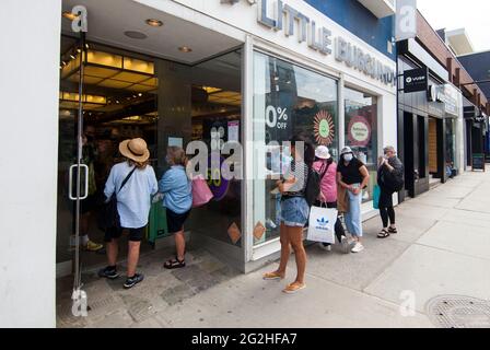 Toronto, Canada. 11th June, 2021. People line up to enter a store in Toronto, Ontario, Canada, on June 11, 2021. Ontario entered step one of its reopening plan on Friday, with stores and restaurants teeming with customers as the province lifted some of its COVID-19 restrictions for the first time in months. Credit: Zou Zheng/Xinhua/Alamy Live News Stock Photo
