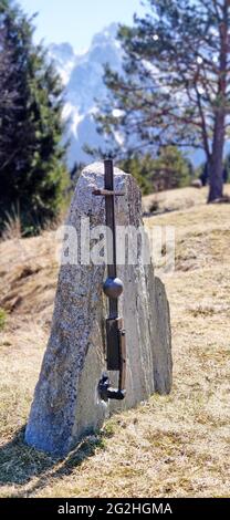 The memorial stone stands without lettering with a simple metal cross on the edge of the forest. The cause and reason are not known Stock Photo