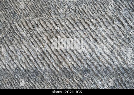 Carved stone surface with deep grooves and furrows Stock Photo