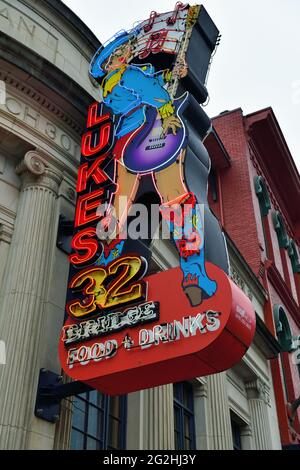 Nashville, Tennessee, USA. Colorful neon, signs abound above and around stores, restaurants and bars along Broadway in the Broadway Historic District. Stock Photo