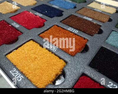 Sliced pieces of carpet. Samples of flooring. Home carpet. Examples of carpets in the catalog. Book with floor coverings. Stock Photo