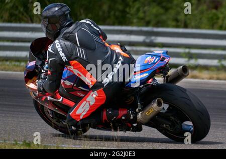 11-05-2020 Kaunas, Lithuania Motorcyclist at sport bike rides by empty asphalt road. sport bike. MotoGP race. Superbikes. Motorbikes racing. Stock Photo