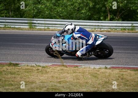 11-05-2020 Kaunas, Lithuania Motorcyclist at sport bike rides by empty asphalt road. sport bike. MotoGP race. Superbikes. Motorbikes racing. Stock Photo