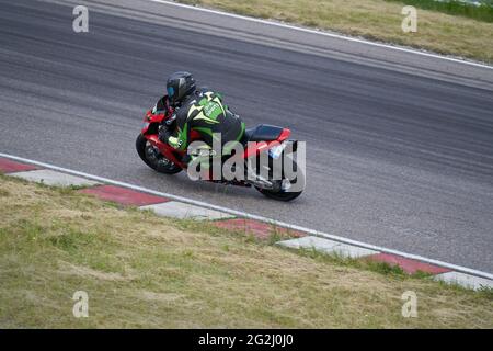 11-05-2020 Kaunas, Lithuania Motorcyclist at sport bike rides by empty asphalt road. sport bike. MotoGP race. Superbikes. Motorbikes racing. Stock Photo