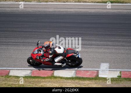 11-05-2020 Kaunas, Lithuania Motorcyclist at sport bike rides by empty asphalt road. sport bike. MotoGP race. Superbikes. Motorbikes racing. Stock Photo