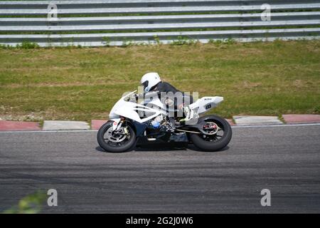 11-05-2020 Kaunas, Lithuania Motorcyclist at sport bike rides by empty asphalt road. sport bike. MotoGP race. Superbikes. Motorbikes racing. Stock Photo