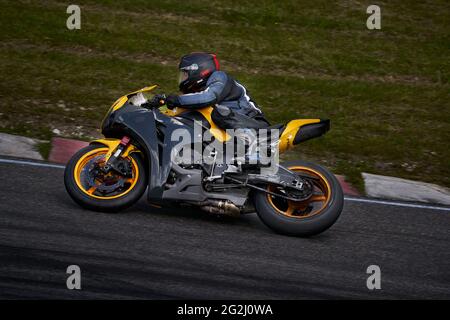 11-05-2020 Kaunas, Lithuania Motorcyclist at sport bike rides by empty asphalt road. sport bike. MotoGP race. Superbikes. Motorbikes racing. Stock Photo