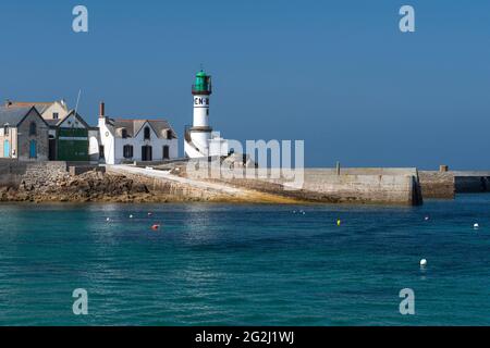 Men Brial lighthouse and houses at the harbor, Île de Sein France, Brittany, Finistère department Stock Photo