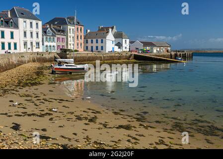 Île de Sein, colorful houses and sailing boat in the harbor, France, Brittany, Finistère department Stock Photo