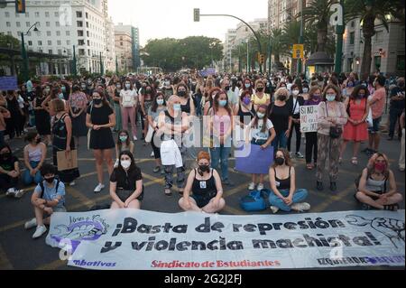 Malaga, Spain. 12th June, 2021. Protesters sitting on the ground as they take a moment of silence in memory of the two girls, during the demonstration. Hundreds of people take the streets against violence on women and gender-based violence after bodies of two girls murderer by the father, Tomas Gimeno were found at the sea from Canary Islands. The crime has shocked the country causing several protests and tributes in memory of the girls. (Photo by Jesus Merida/SOPA Images/Sipa USA) Credit: Sipa USA/Alamy Live News Stock Photo
