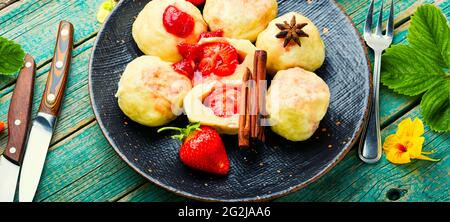 Traditional european dumplings with berries.Dumplings with strawberries or knedlik.Cottage cheese dumplings with strawberry Stock Photo
